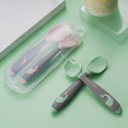 Baby learning to eat spoon and fork