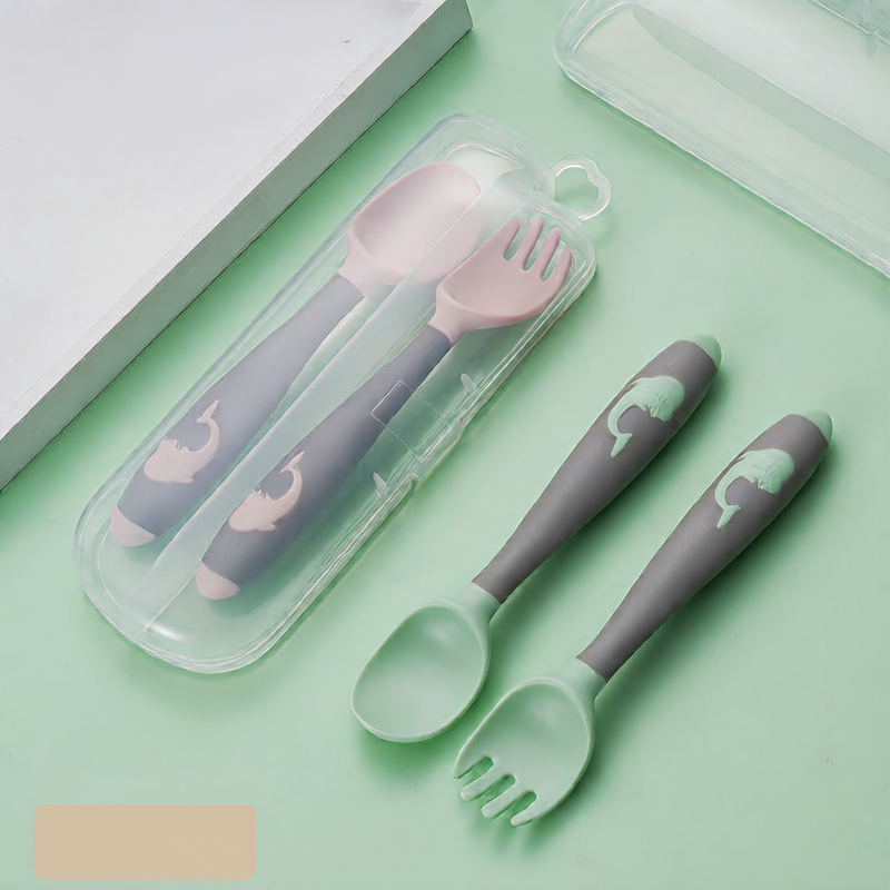 Baby learning to eat spoon and fork