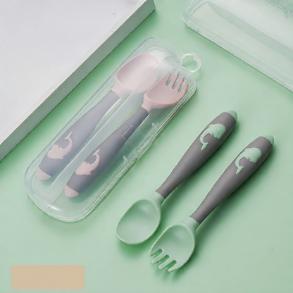 Baby learning to eat spoon and fork